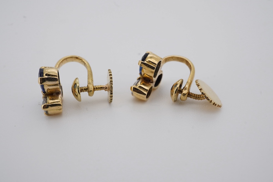 A modern pair of yellow metal and three stone blue and white sapphire cluster set ear clips, approx. 8mm, gross weight 3 grams. Condition - poor to fair